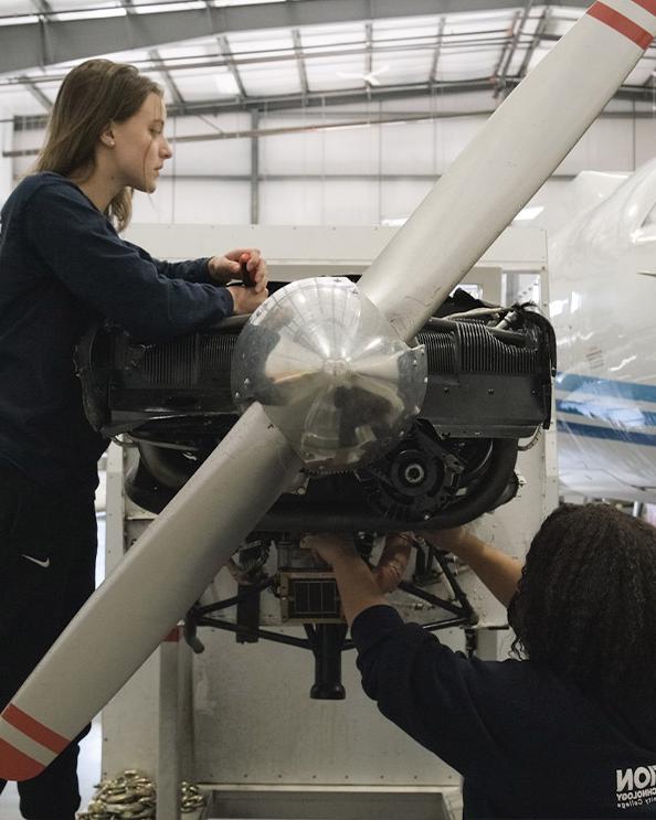 Female students working on an engine